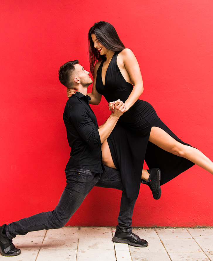 image of man and woman in tango, red background